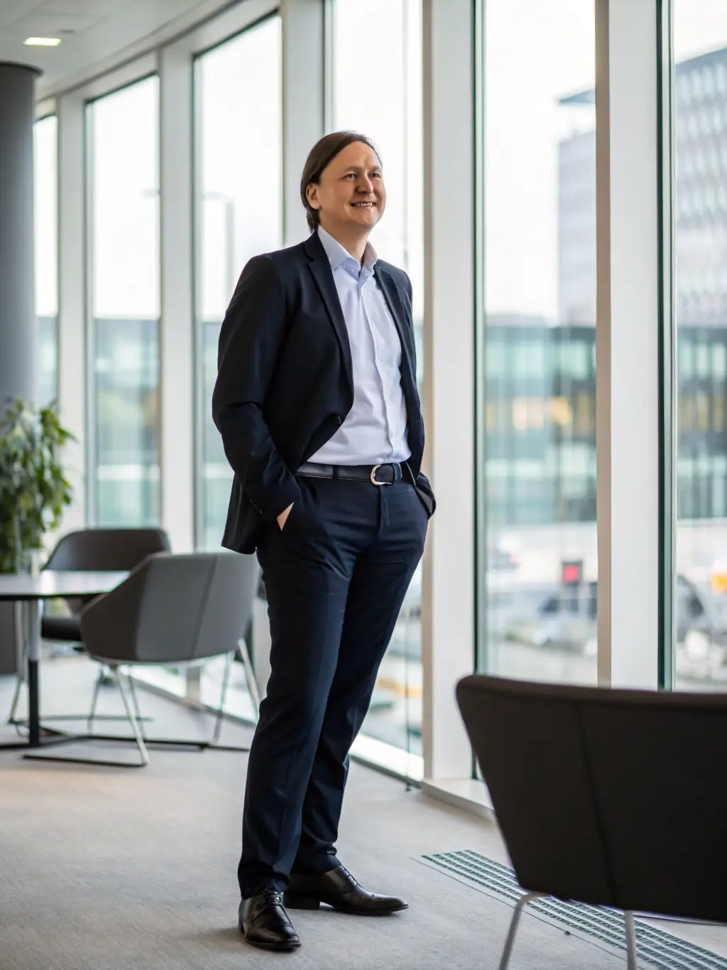 A photographer taking professional headshots in a corporate office setting, emphasizing business photography services.